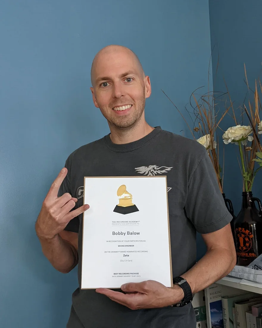 Bobby Balow holding his Recording Academy certificate for his work as mixing engineer on the Grammy-nominated recording Zeta.